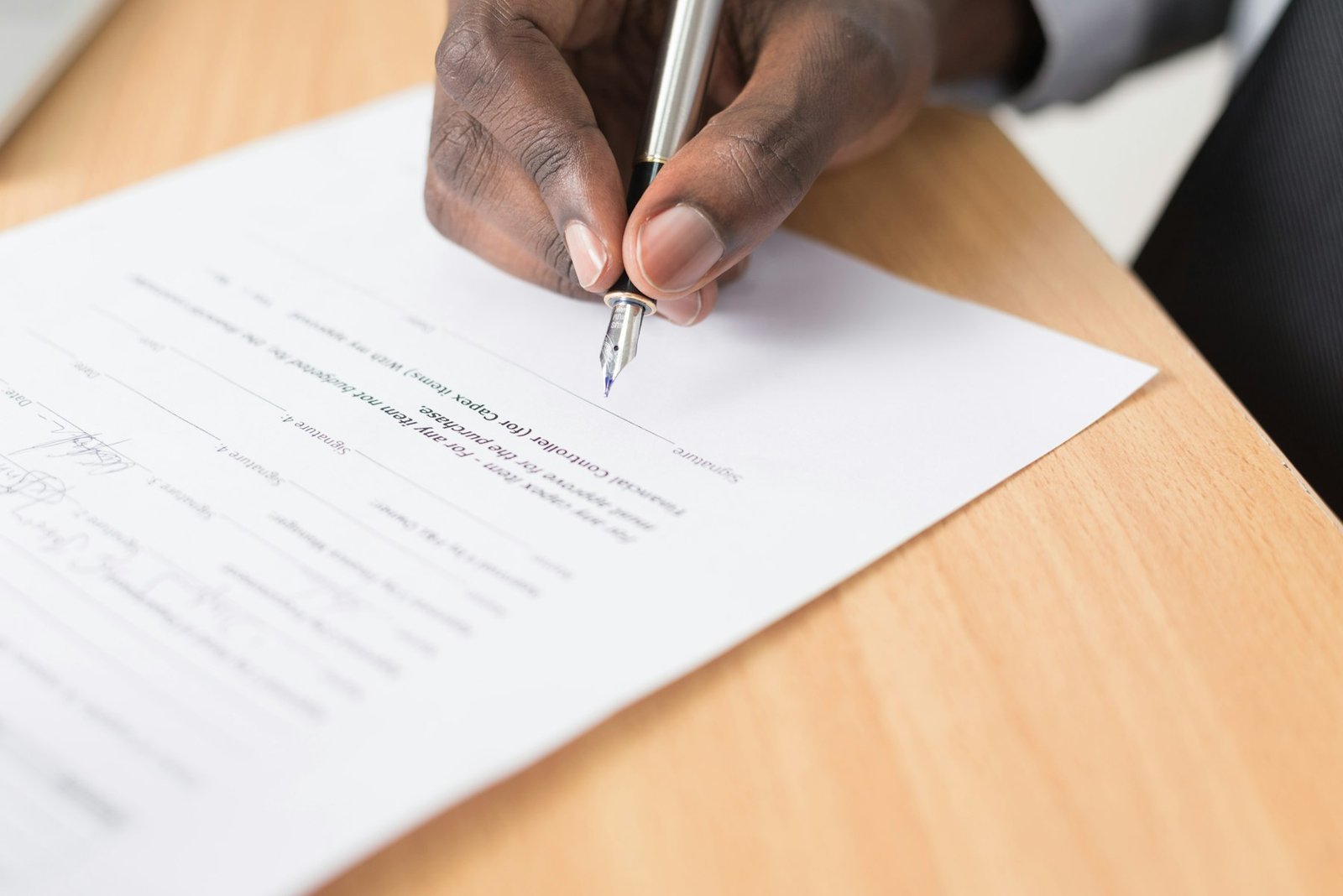 A person reviewing paperwork at a desk