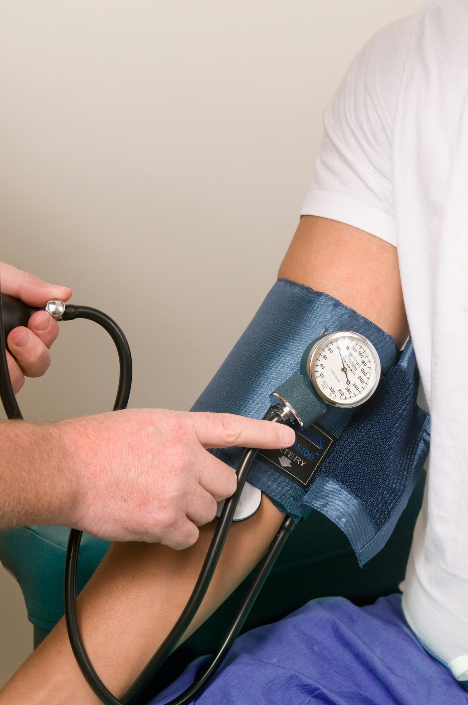 A clinician taking a patient blood pressure reading