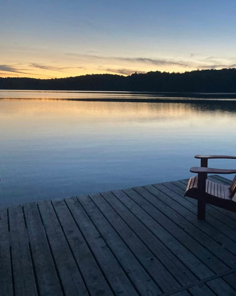 A calm lake at dusk with the last of the light on the water